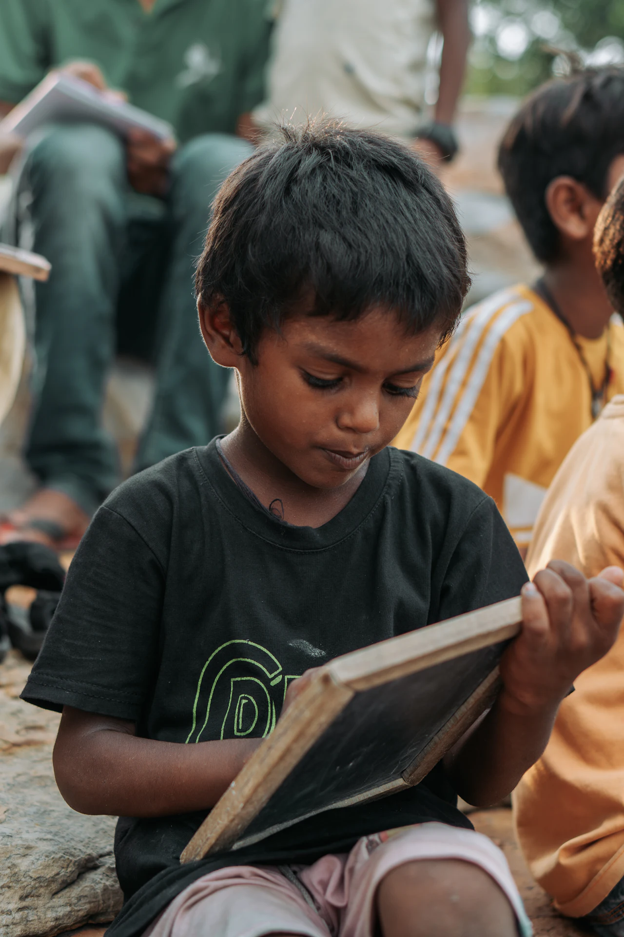 A boy reading and writing at his desk