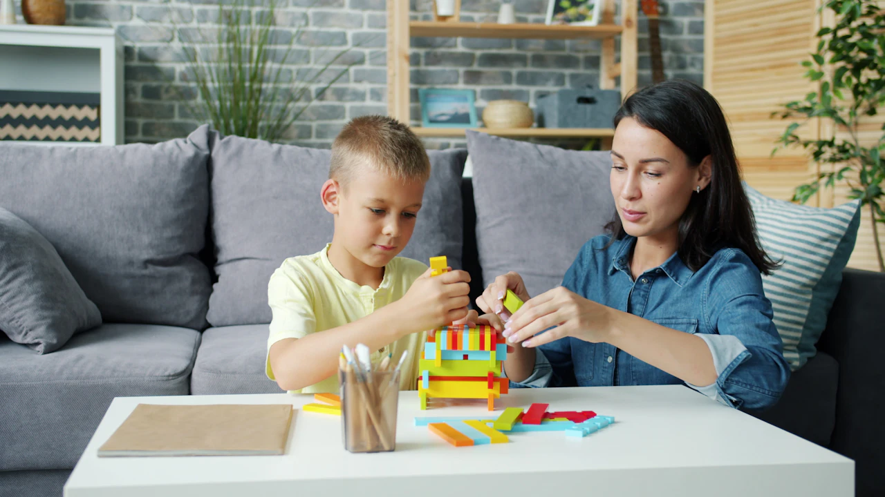 A mother and her son building with colourful blocks