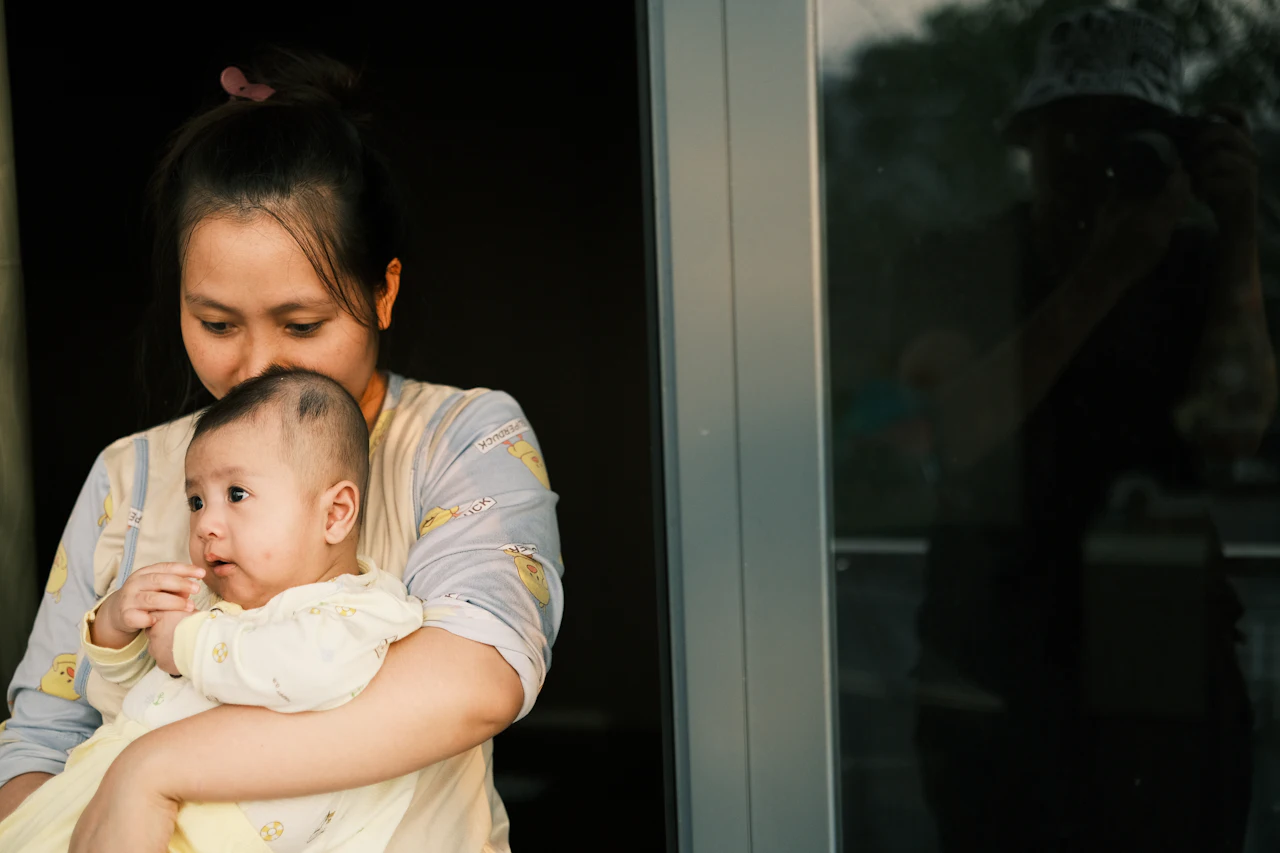 A parent holding their young child close