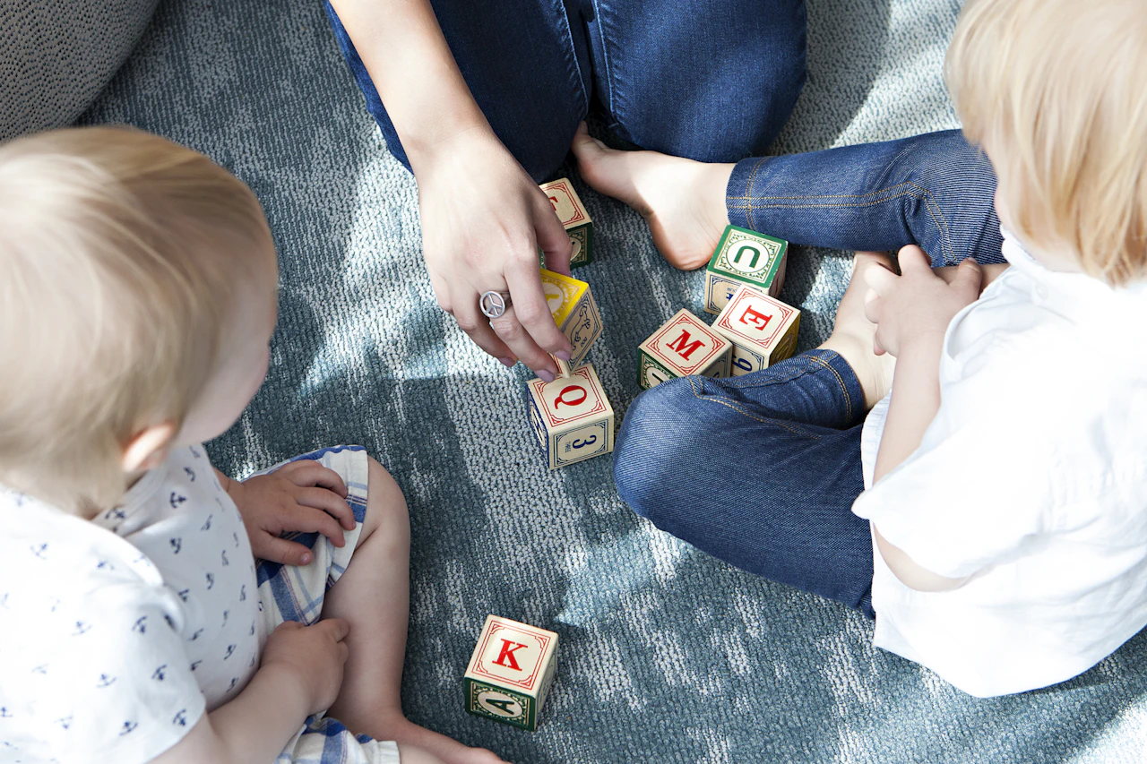 Young children playing with letter blocks